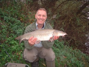 A Nice Barbel for Pete, taken whilst holding the rod!